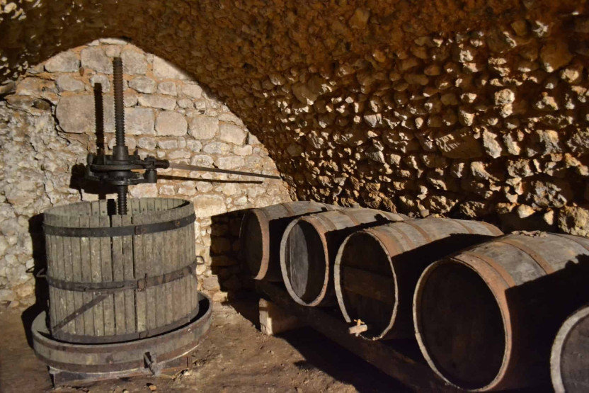 Wine press and old wine barrels.